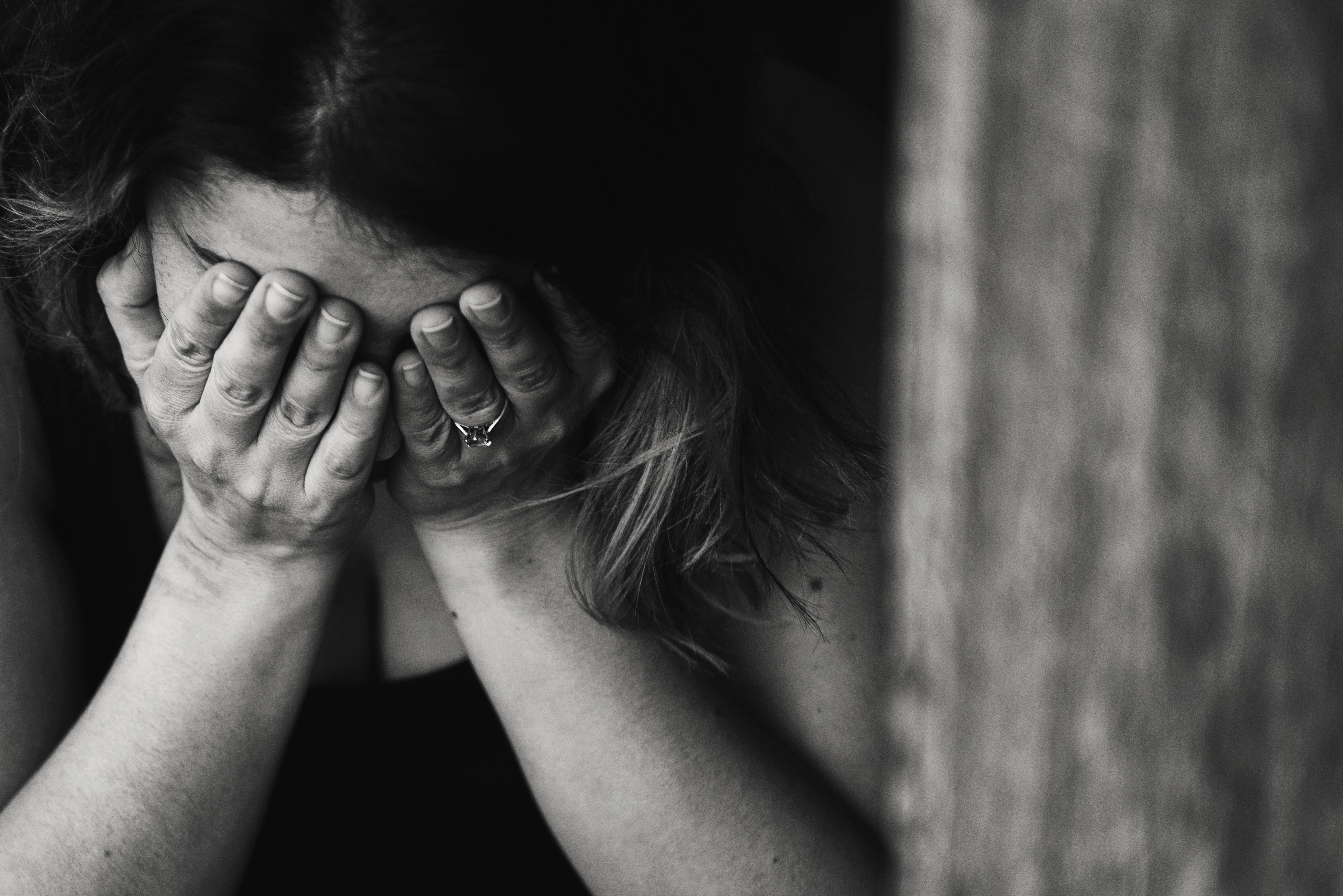 Woman holding her head in her hands