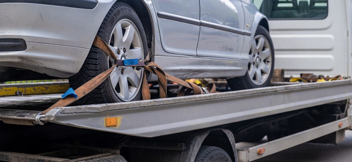 Loaded Broken Car On A Tow Truck. Car Being Towed. Damage Vehicl