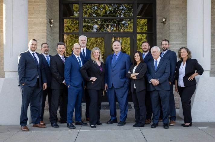Group photo of an Ohio traffic accident attorney team standing in front of their law office.