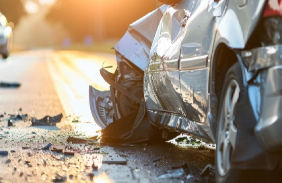 Severely damaged car after a rear-end collision with debris scattered on an Ohio roadway.